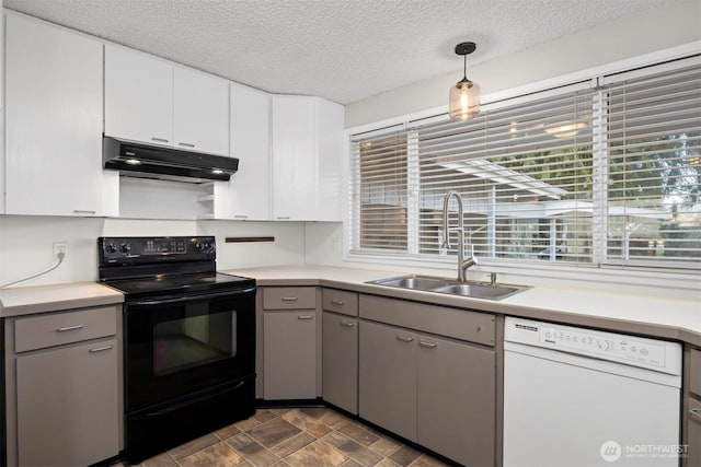 kitchen with under cabinet range hood, dishwasher, gray cabinets, electric range, and a sink