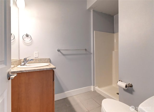 full bath with vanity, baseboards, walk in shower, tile patterned floors, and toilet