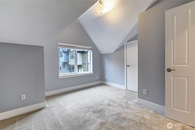 bonus room with vaulted ceiling, baseboards, and carpet floors