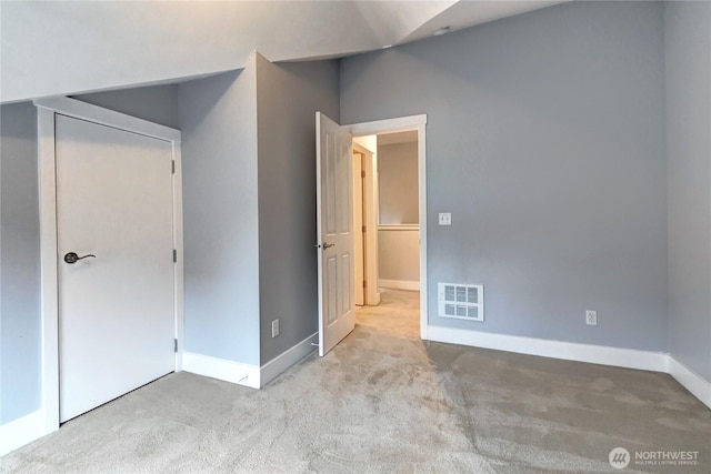 unfurnished bedroom featuring visible vents, carpet flooring, and baseboards