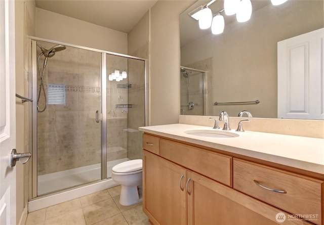 bathroom featuring tile patterned flooring, toilet, and a stall shower