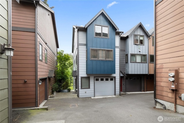 5939 Delridge Way SW, Seattle, WA 98106 - view of front of house featuring board and batten siding, a garage, and asphalt driveway