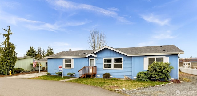 single story home featuring roof with shingles