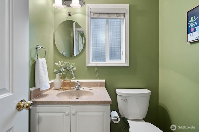 bathroom featuring toilet and vanity