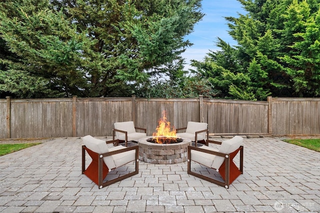 view of patio / terrace with an outdoor fire pit and a fenced backyard