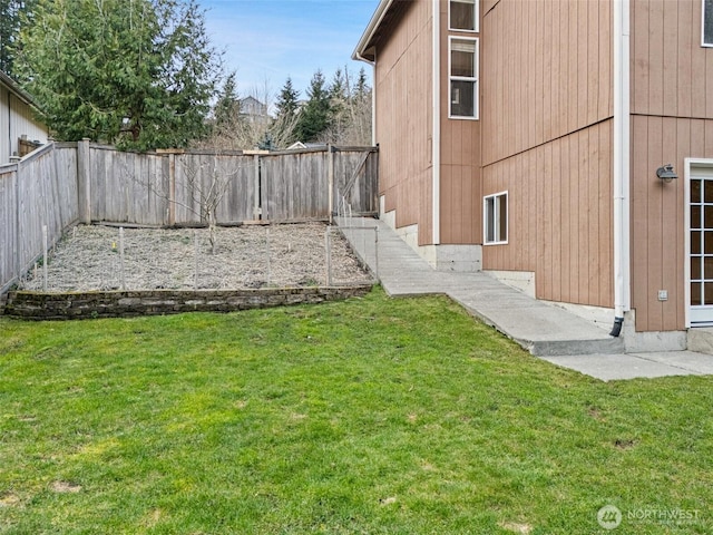 view of yard with a fenced backyard and a vegetable garden