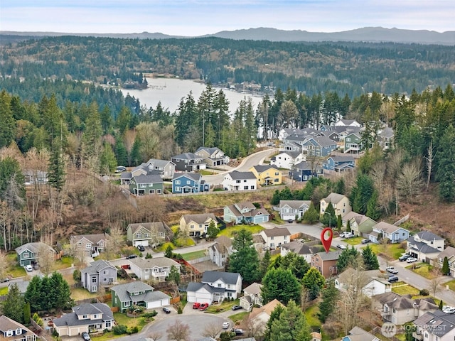 birds eye view of property with a forest view, a residential view, and a mountain view