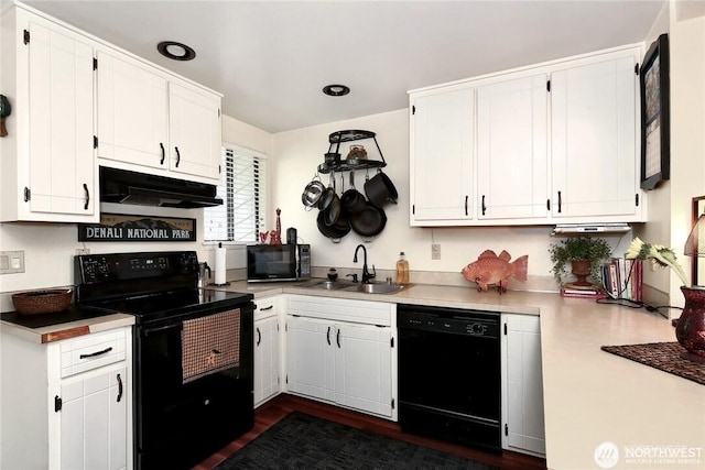 kitchen featuring a sink, black appliances, light countertops, under cabinet range hood, and white cabinetry