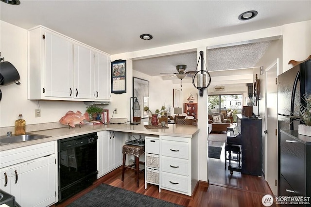 kitchen featuring dark wood-style flooring, ceiling fan, black appliances, light countertops, and white cabinetry