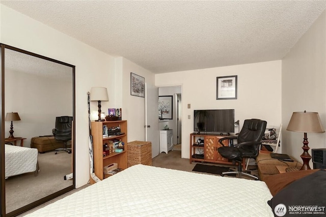 bedroom featuring carpet floors and a textured ceiling