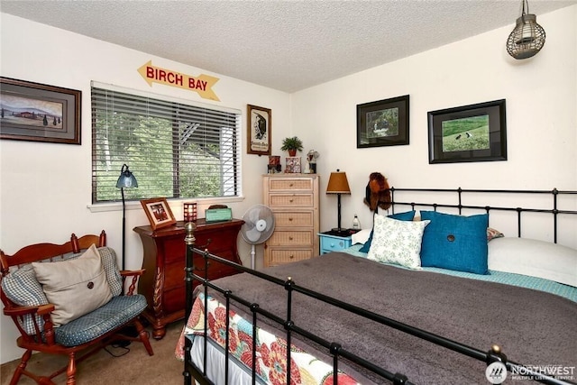 carpeted bedroom featuring a textured ceiling