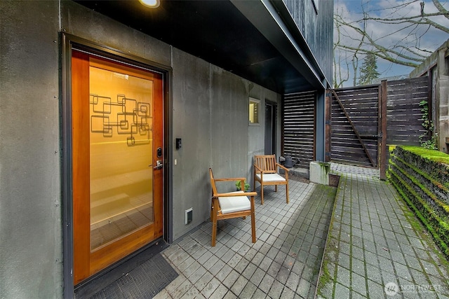 entrance to property featuring stucco siding