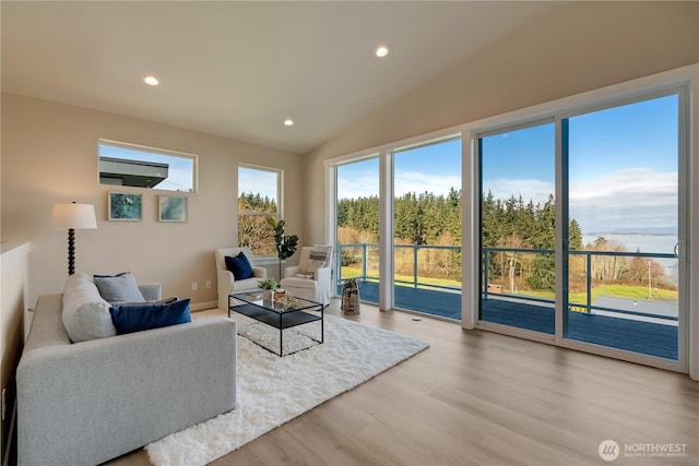 living room with recessed lighting, vaulted ceiling, and wood finished floors