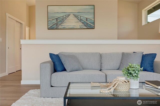 living area featuring wood finished floors and baseboards