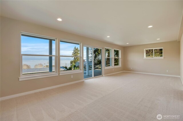 carpeted spare room with recessed lighting and baseboards