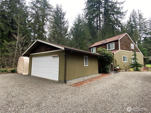 view of front facade with a detached garage and an outdoor structure