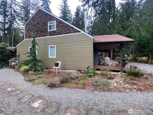 view of home's exterior with roof with shingles