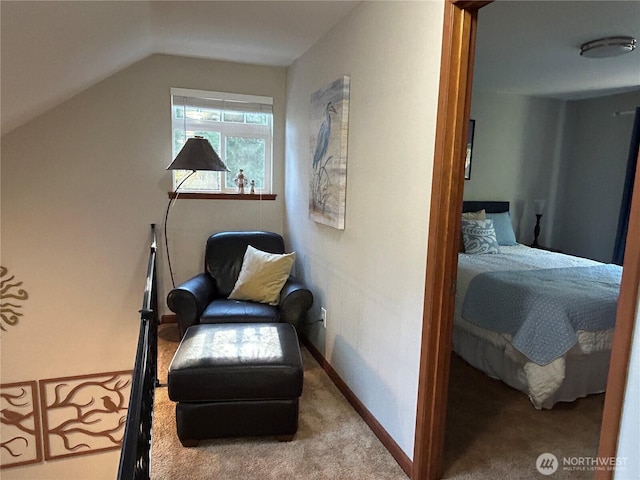 sitting room featuring lofted ceiling, carpet, and baseboards