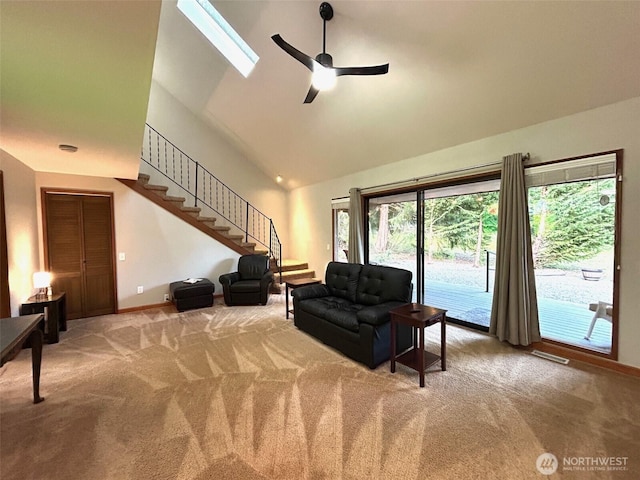 living area featuring carpet, visible vents, ceiling fan, high vaulted ceiling, and stairs