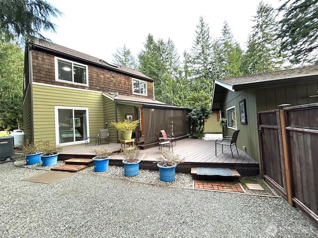 rear view of property featuring a wooden deck