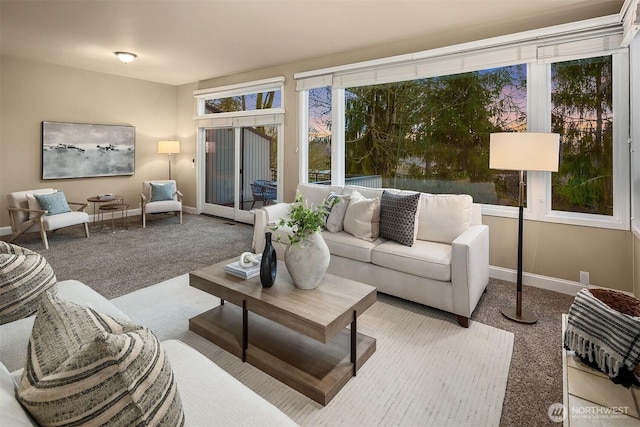 carpeted living room featuring baseboards