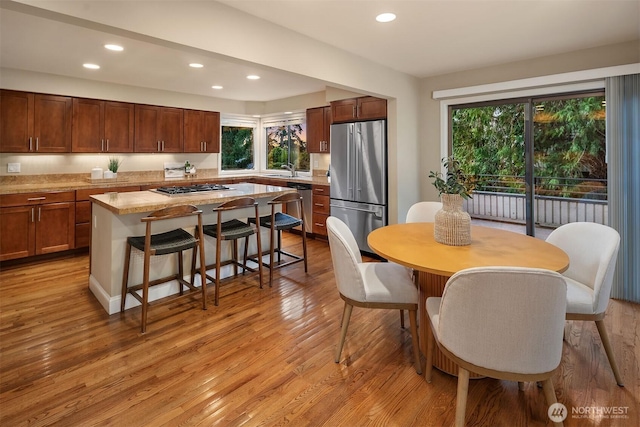 dining space featuring recessed lighting and light wood-style flooring