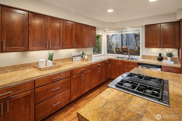 kitchen with a sink, wood finished floors, recessed lighting, stovetop with downdraft, and dishwasher