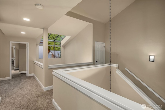 hallway featuring baseboards, carpet floors, an upstairs landing, vaulted ceiling, and recessed lighting