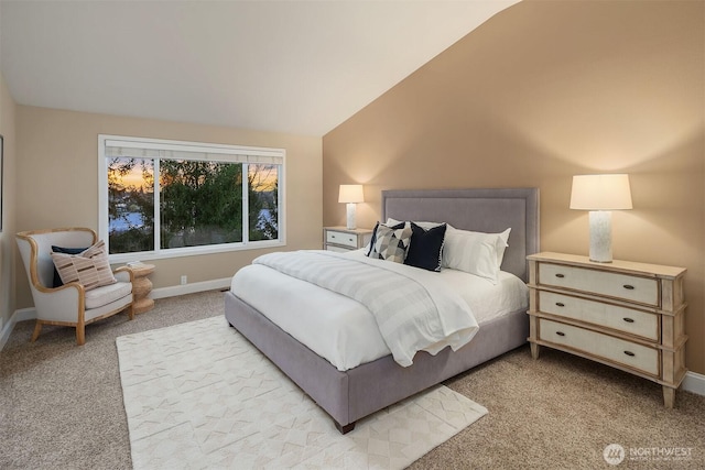 bedroom with baseboards, light carpet, and vaulted ceiling