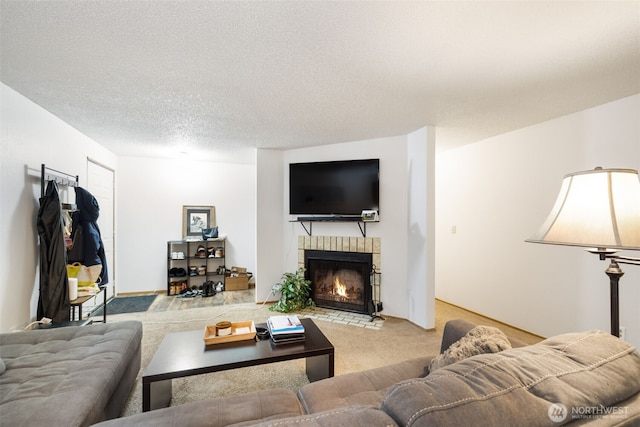 living room with carpet floors, a fireplace, and a textured ceiling