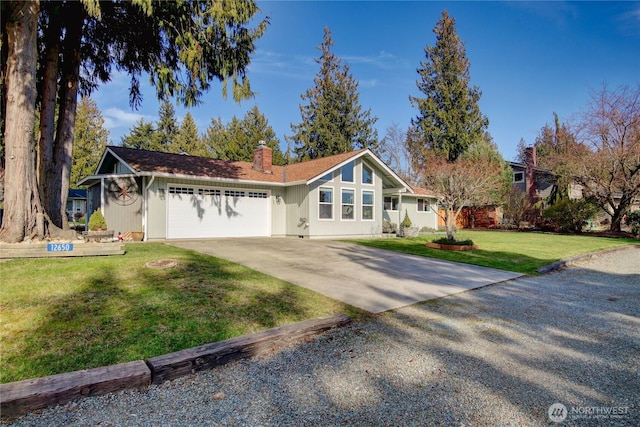 view of front facade featuring a garage, a front lawn, a chimney, and driveway