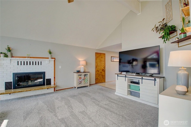 living room featuring beam ceiling, high vaulted ceiling, a fireplace, and carpet flooring