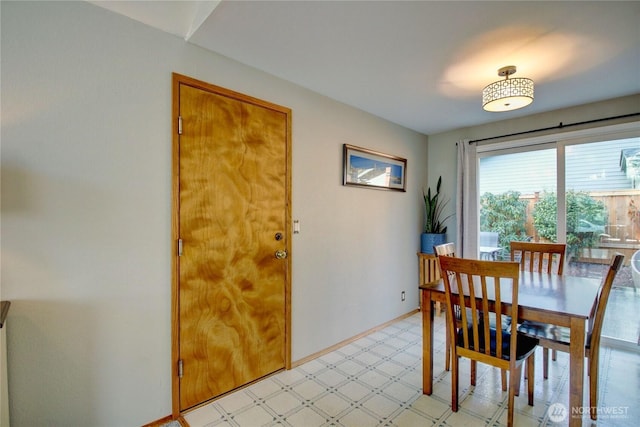 dining area with light floors and baseboards