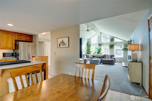 dining room with lofted ceiling with beams, recessed lighting, a ceiling fan, and light carpet