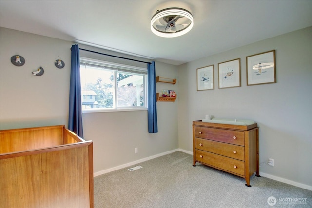 bedroom with visible vents, light carpet, and baseboards