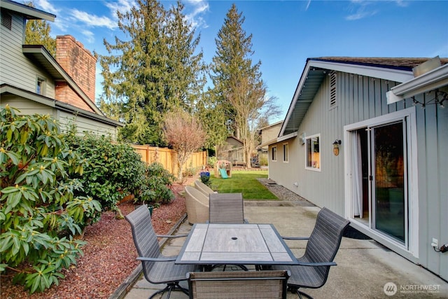 view of patio with outdoor dining area and fence