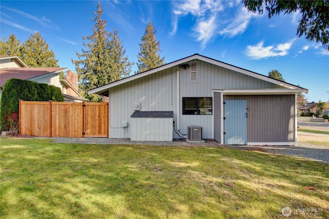 view of outbuilding with fence and central AC