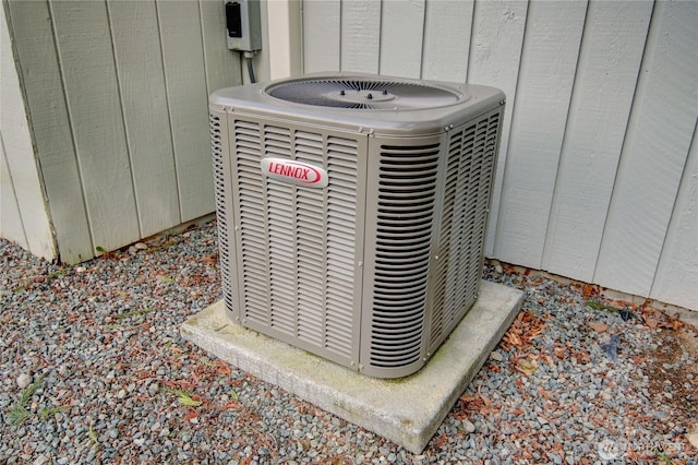 exterior details with board and batten siding and central AC