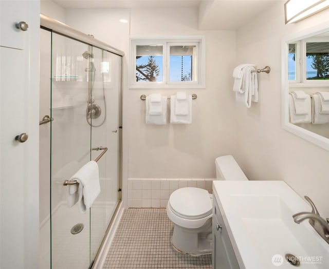 full bathroom featuring a stall shower, vanity, toilet, and tile patterned floors