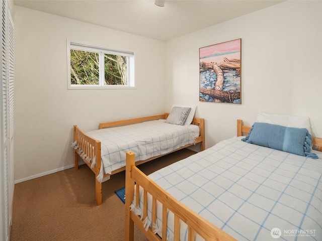 bedroom with a closet, baseboards, and carpet flooring