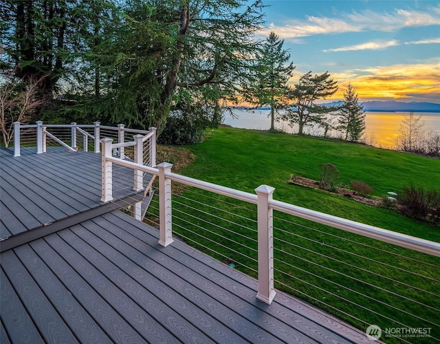 wooden terrace featuring a yard