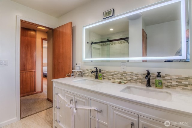 full bath with double vanity, a sink, and decorative backsplash