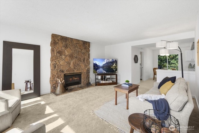 living room with a textured ceiling, a fireplace, and light colored carpet