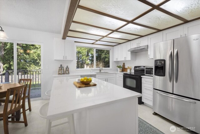 kitchen featuring black electric range, stainless steel refrigerator with ice dispenser, white cabinets, a sink, and under cabinet range hood