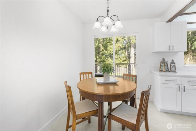 dining room featuring baseboards and a chandelier