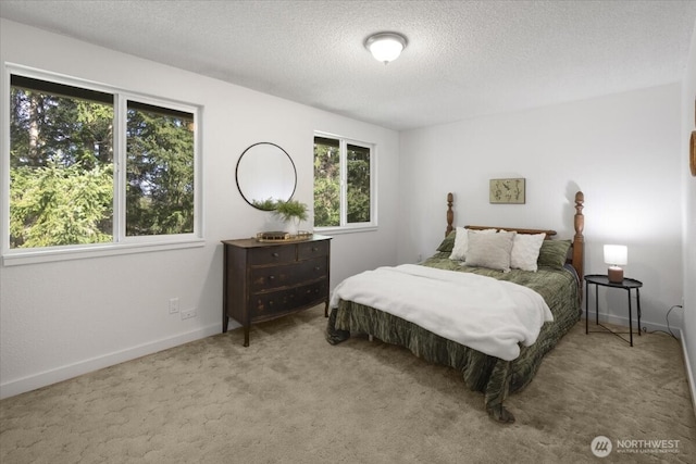 bedroom featuring a textured ceiling, multiple windows, carpet flooring, and baseboards