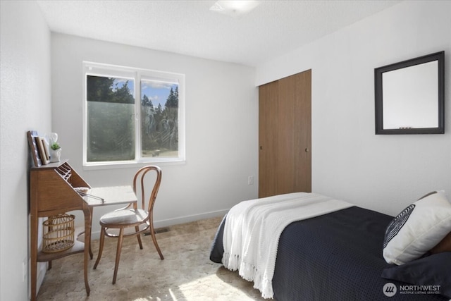 bedroom with a closet and baseboards