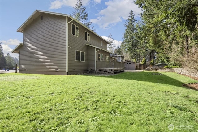 back of house featuring a yard and a deck