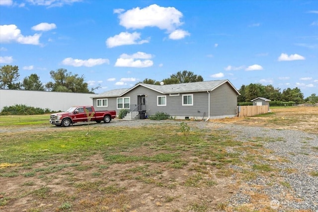 single story home featuring fence and a front yard