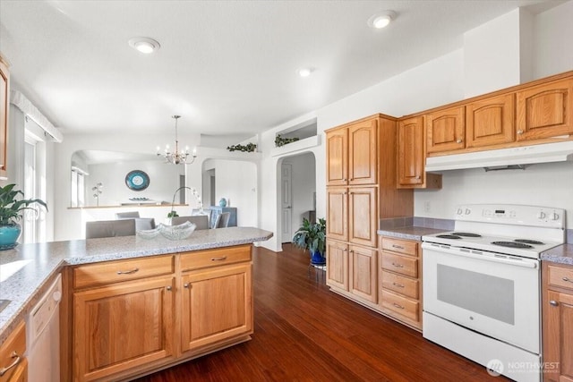 kitchen with white appliances, under cabinet range hood, arched walkways, and dark wood-type flooring